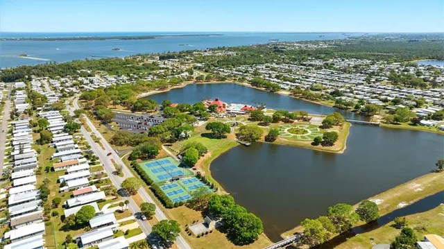 an aerial view of a house with a yard and lake view