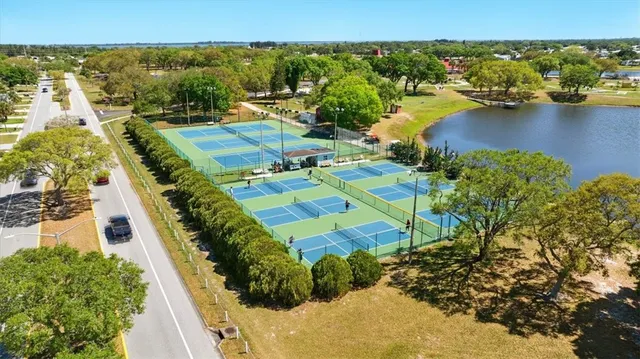 an aerial view of a swimming pool with outdoor seating and yard