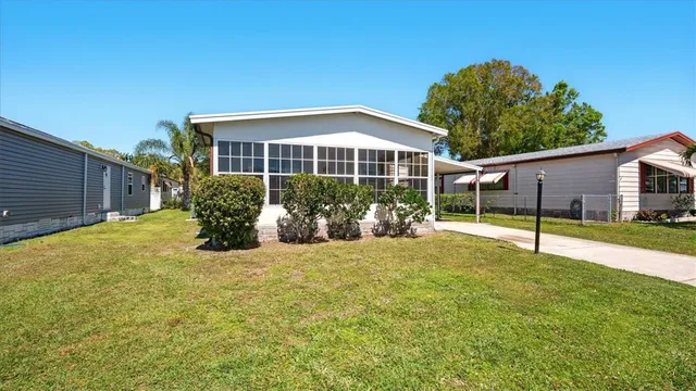 a view of a house with backyard and porch