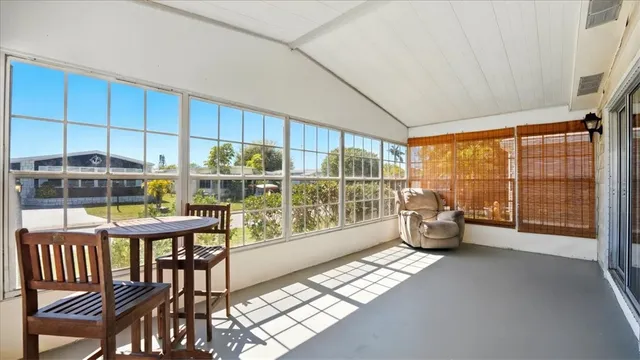 a view of a living room hardwood floor and a large window