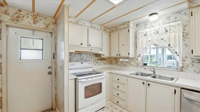 a white refrigerator freezer sitting inside of a kitchen