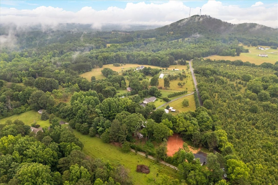 174 Holliday Road Six Mile, SC 29682 - Photo 43 of 49 Breathtaking aerial views capture verdant landscapes with distant mountains and scattered neighboring homes
