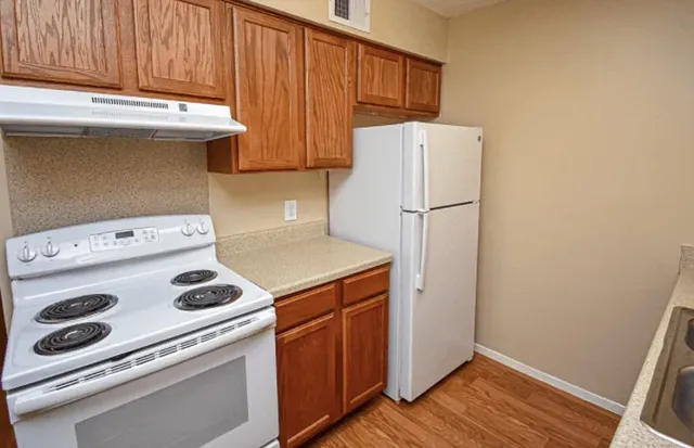 a kitchen with a stove and a refrigerator