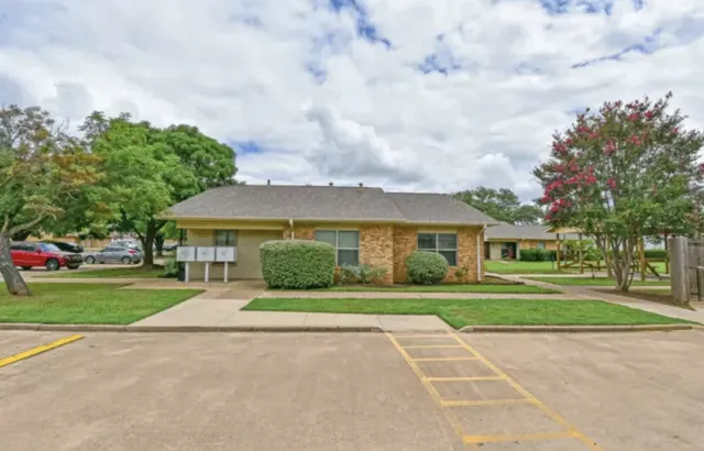 front view of a house next to a yard