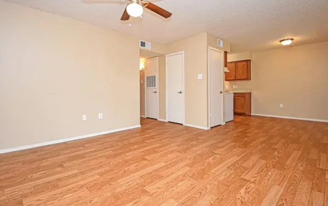 a view of an empty room with a ceiling fan