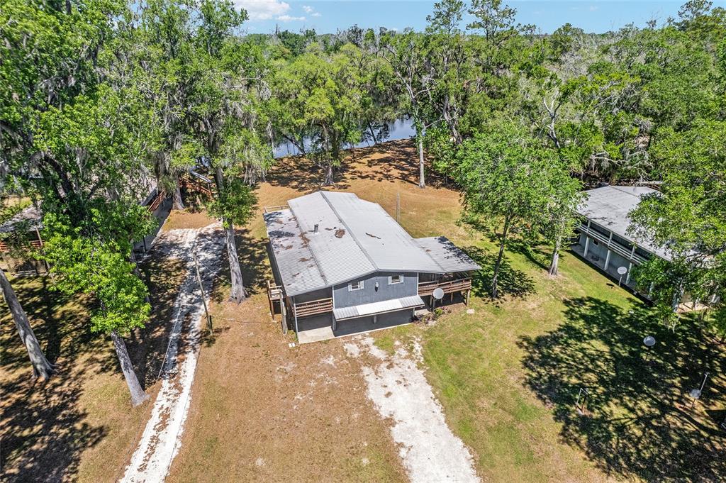 7870 Southwest 25th Place Bell, FL 32619 - Photo 16 of 93 an aerial view of a swimming pool with lawn chairs and plants