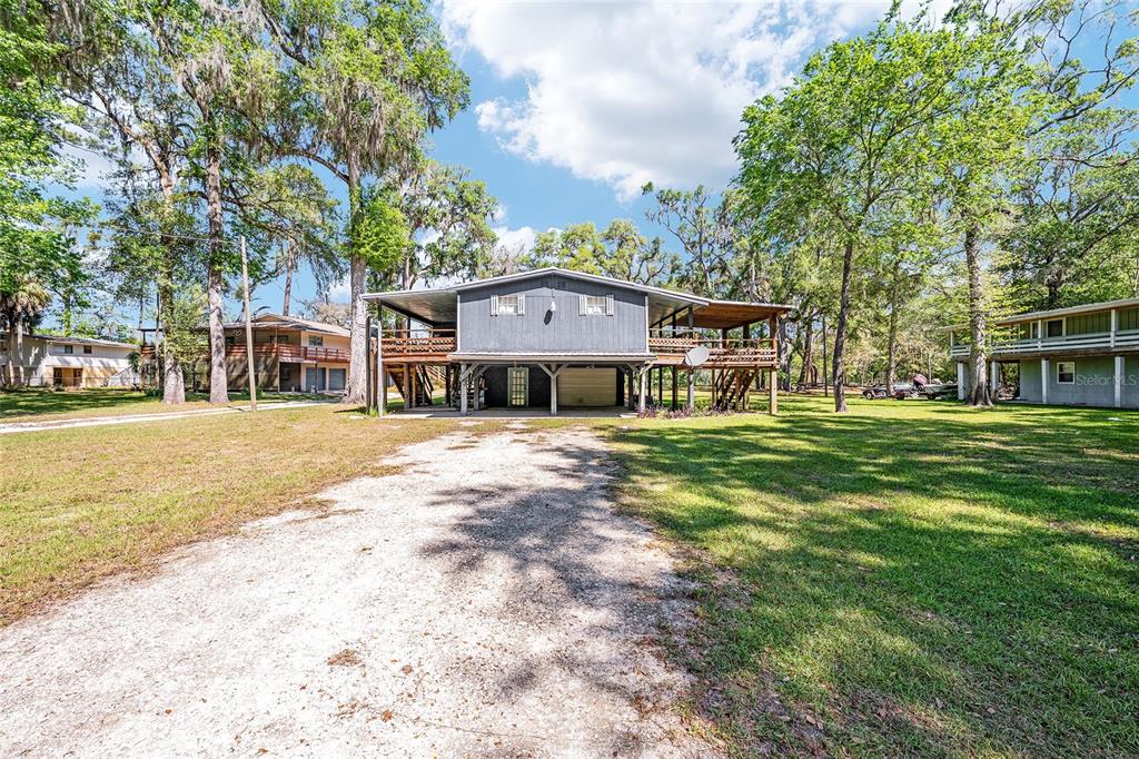 7870 Southwest 25th Place Bell, FL 32619 - Photo 28 of 93 a front view of a house with a garden