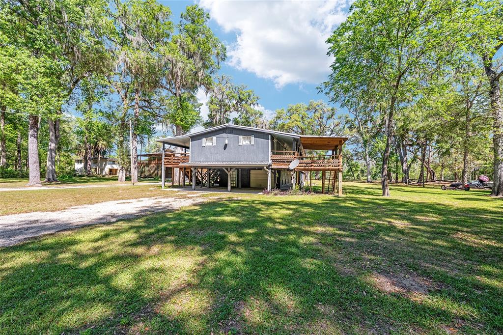 7870 Southwest 25th Place Bell, FL 32619 - Photo 29 of 93 a view of a big house with a big yard and large trees