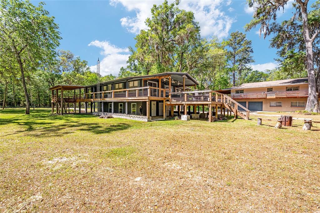 7870 Southwest 25th Place Bell, FL 32619 - Photo 36 of 93 a view of a house with a swimming pool and sitting area