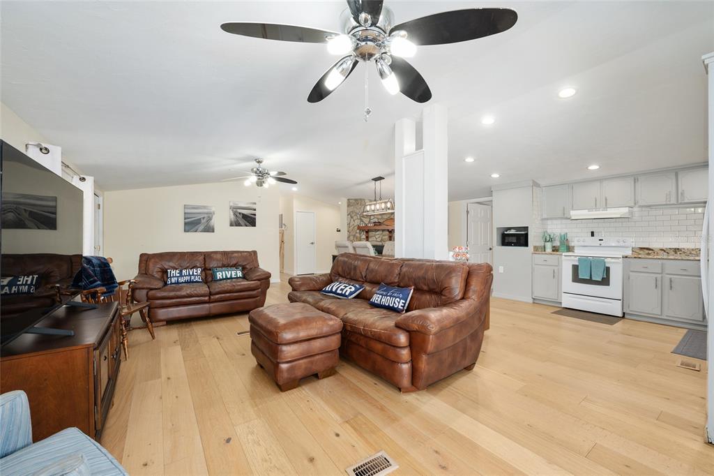 7870 Southwest 25th Place Bell, FL 32619 - Photo 64 of 93 a living room with furniture and a wooden floor