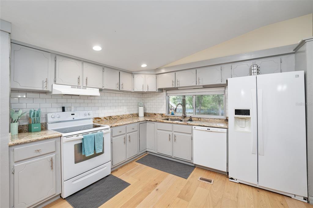7870 Southwest 25th Place Bell, FL 32619 - Photo 70 of 93 a kitchen with white cabinets and white appliances