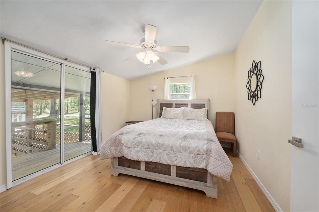 7870 Southwest 25th Place Bell, FL 32619 - Photo 81 of 93 a bedroom with a large bed and a chandelier