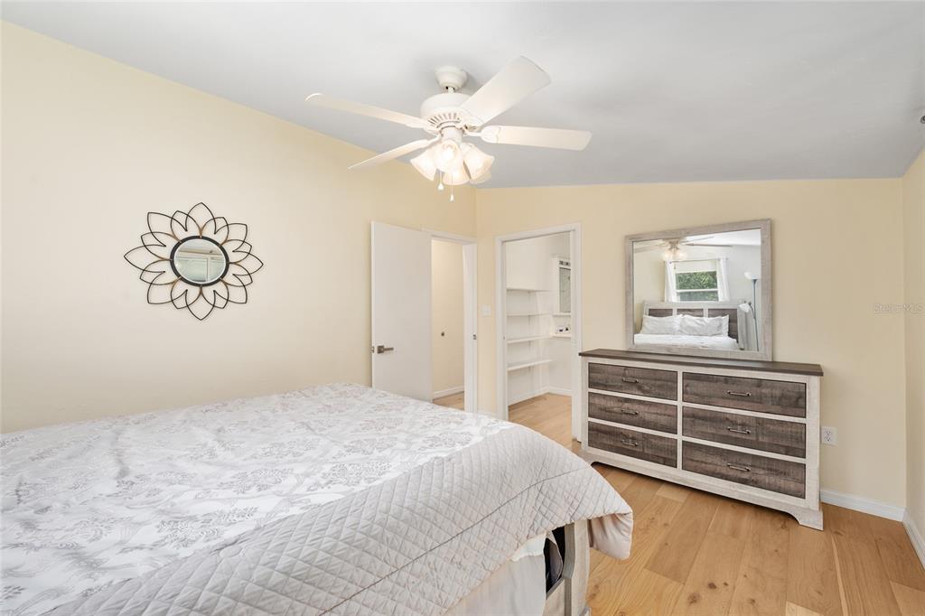 7870 Southwest 25th Place Bell, FL 32619 - Photo 82 of 93 a bedroom with a bed and a chandelier