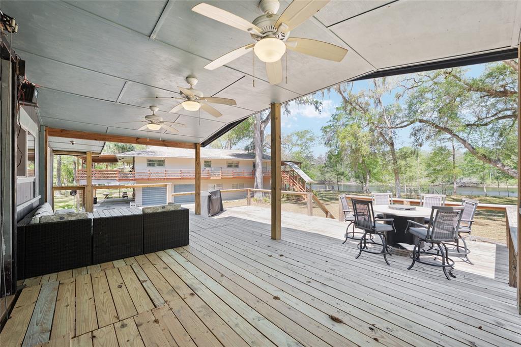7870 Southwest 25th Place Bell, FL 32619 - Photo 90 of 93 a view of a dining room with furniture large windows and wooden floor