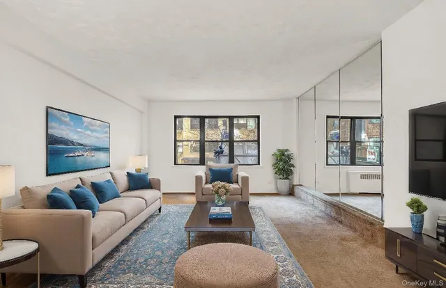 a living room with furniture large window and glass door