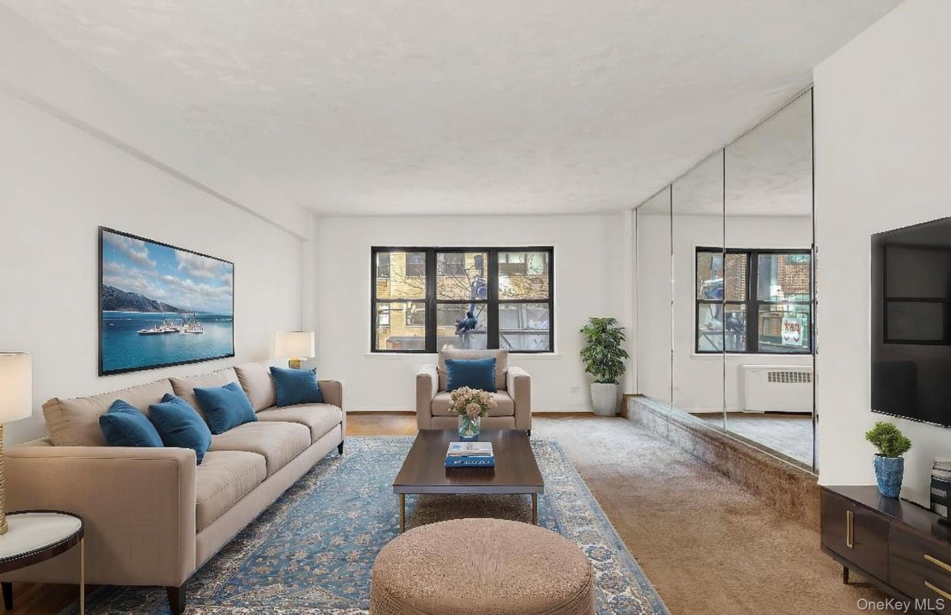 a living room with furniture large window and glass door