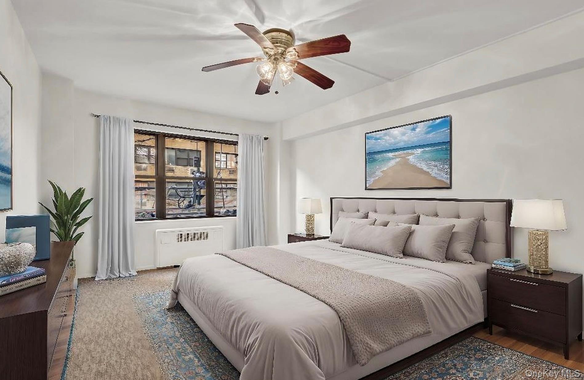 301 East 48th Street, Unit 2C Manhattan, NY 10017 - Photo 15 of 22 a bedroom with a large bed and a chandelier