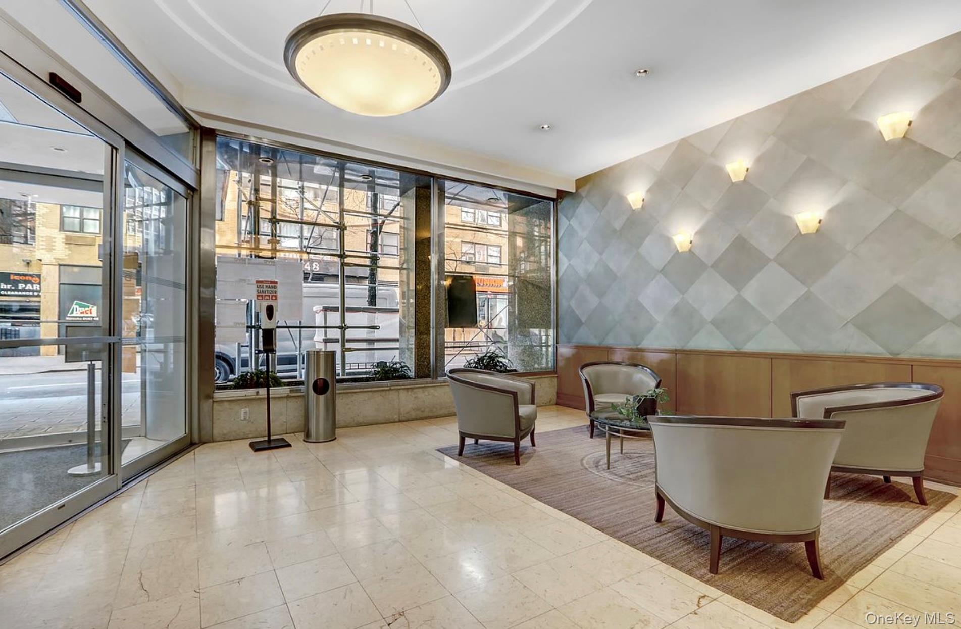 301 East 48th Street, Unit 2C Manhattan, NY 10017 - Photo 19 of 22 a living room with a couch and a table