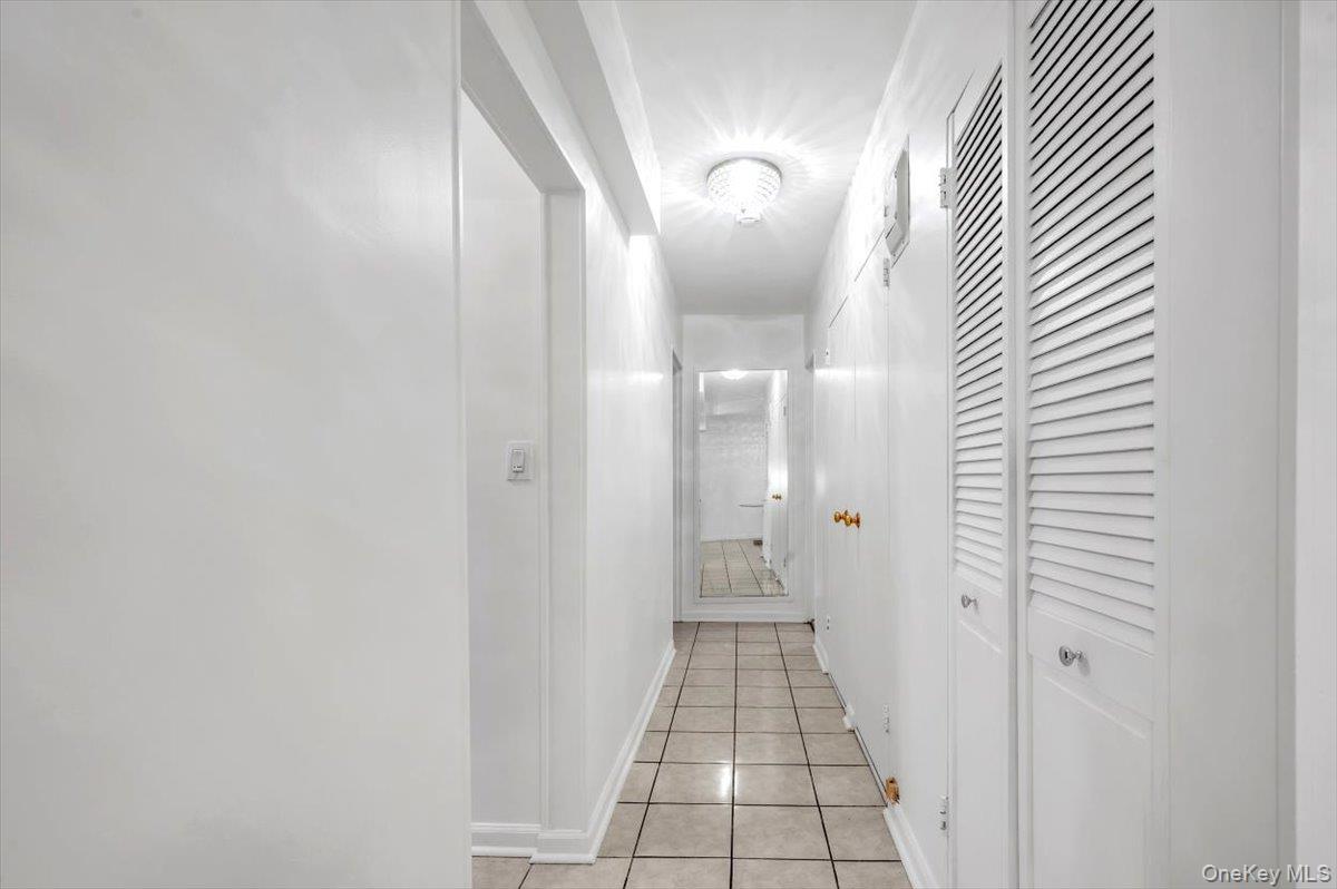 301 East 48th Street, Unit 2C Manhattan, NY 10017 - Photo 8 of 22 a view of a bathroom from a hallway