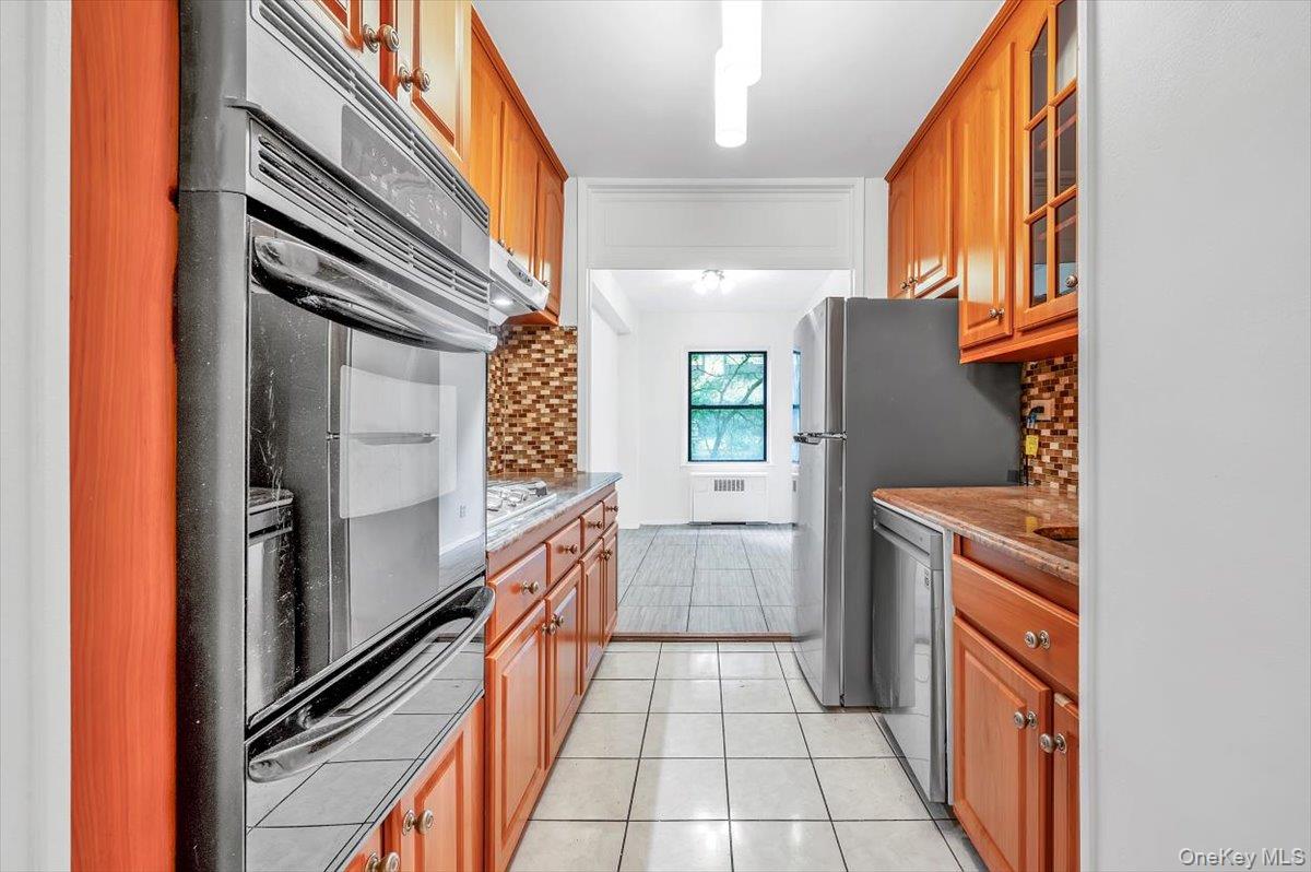 301 East 48th Street, Unit 2C Manhattan, NY 10017 - Photo 9 of 22 a kitchen with a refrigerator a sink and dishwasher