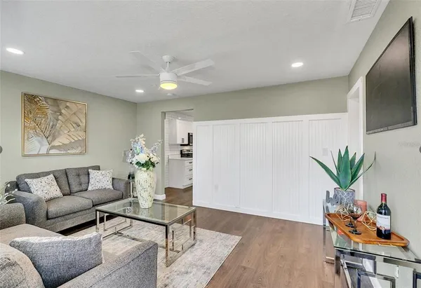 a living room with furniture potted plant and a window