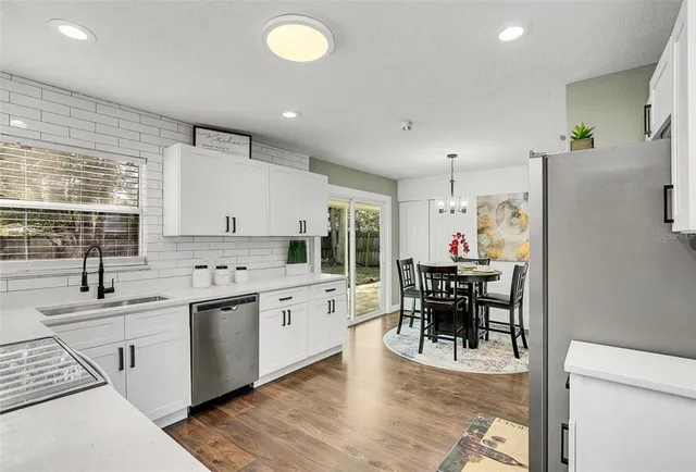 a kitchen with stainless steel appliances kitchen island granite countertop a sink and cabinets