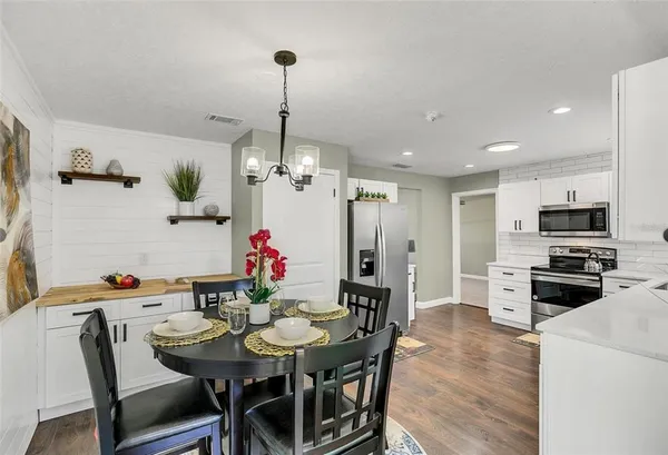 a view of a dining room with furniture and wooden floor