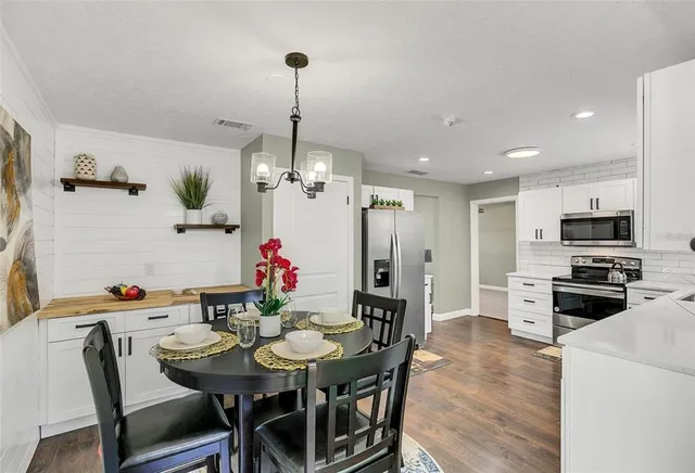 a view of a dining room with furniture and wooden floor