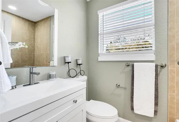a bathroom with a sink toilet and mirror