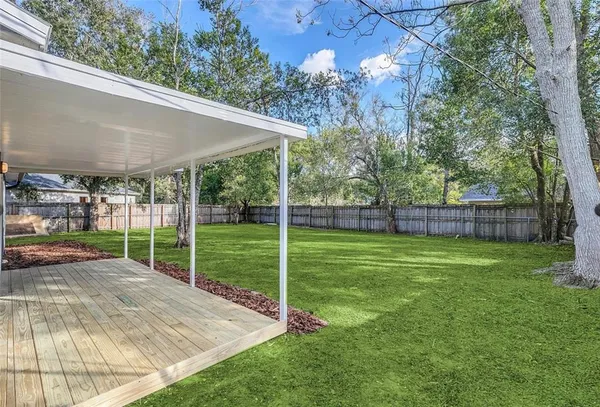 a view of a house with backyard and porch