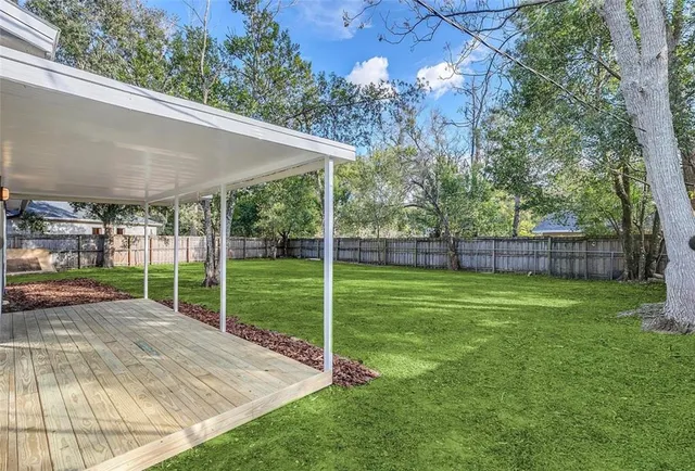 a view of a house with backyard and porch