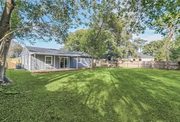 a view of a house with a yard and sitting area