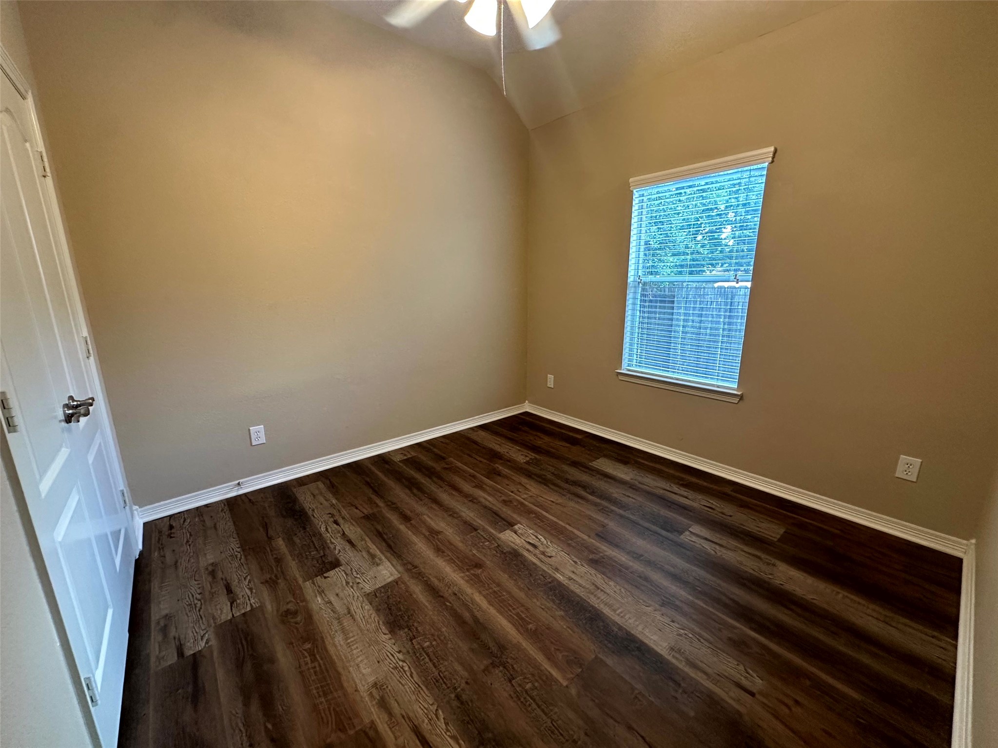 2047 Lulach Lane Conroe, TX 77301 - Photo 15 of 20 a view of an empty room with wooden floor and a window