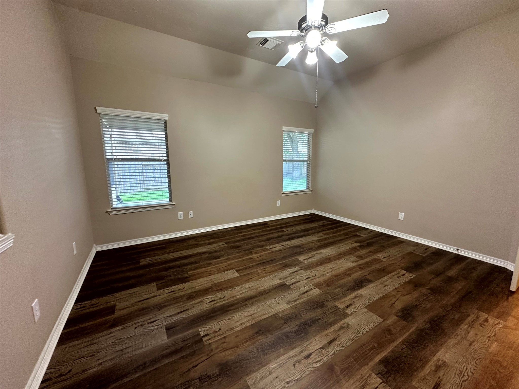 2047 Lulach Lane Conroe, TX 77301 - Photo 16 of 20 a view of an empty room with wooden floor and a window