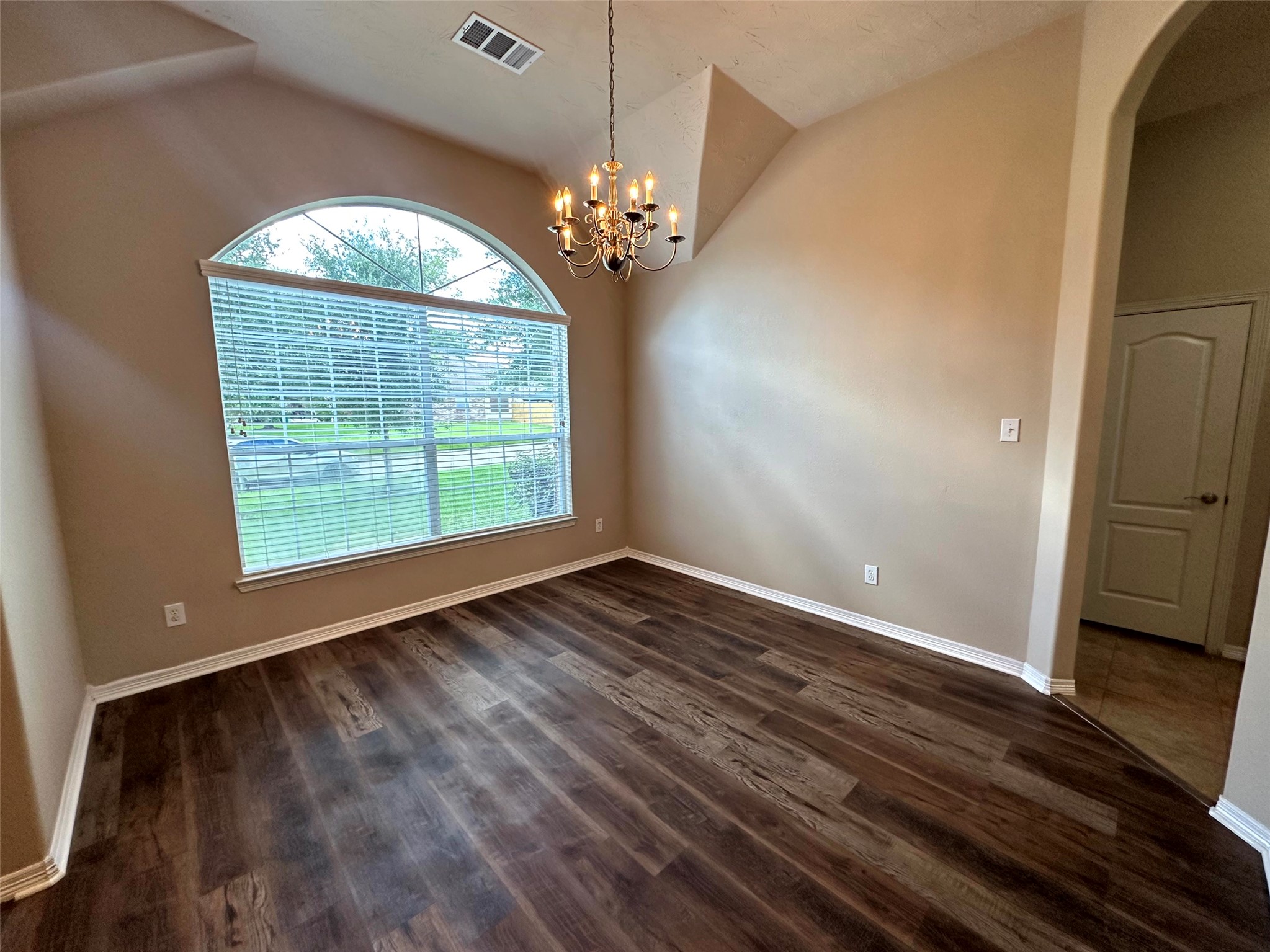 2047 Lulach Lane Conroe, TX 77301 - Photo 3 of 20 a view of an empty room with wooden floor and a window