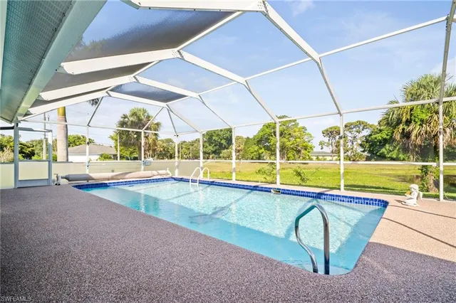 a view of a swimming pool with a backyard