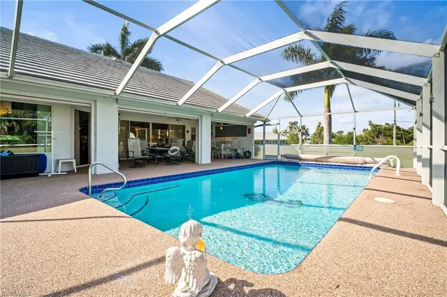 a view of a swimming pool with a patio and a garden