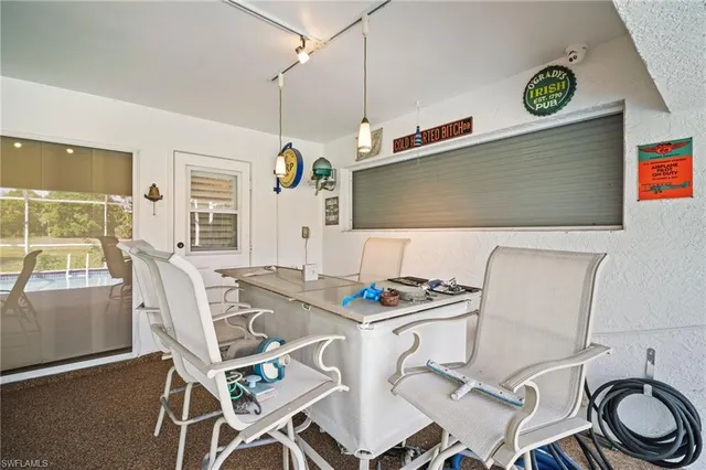 a view of a kitchen with dining area and windows