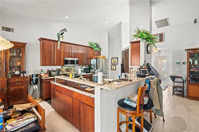 a view of a kitchen with furniture and a potted plant