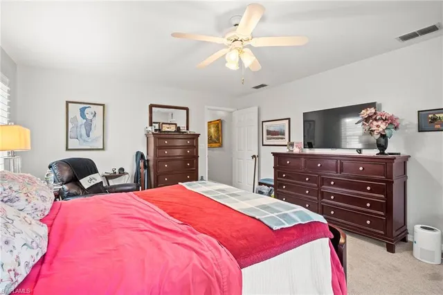 a bedroom with a bed and a dresser in it
