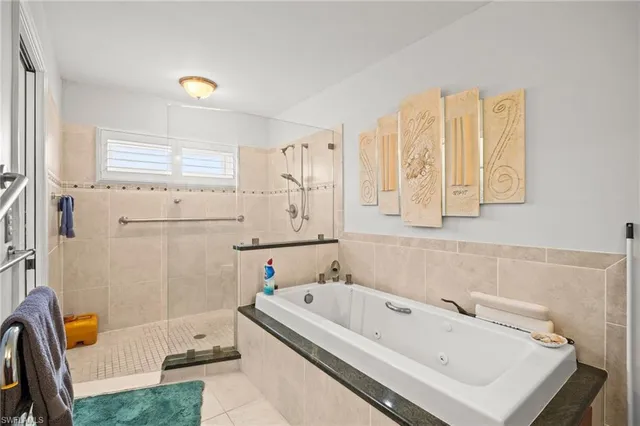 a bathroom with a tub a sink and a window