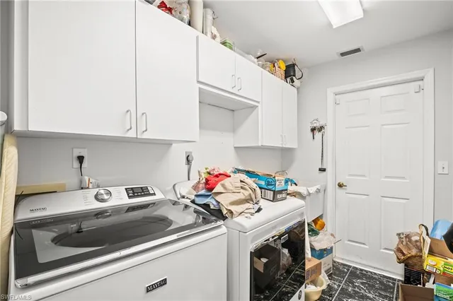 a utility room with sink dryer and washer