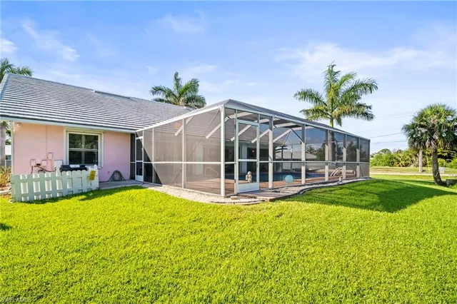 a view of a house with a garden and swimming pool