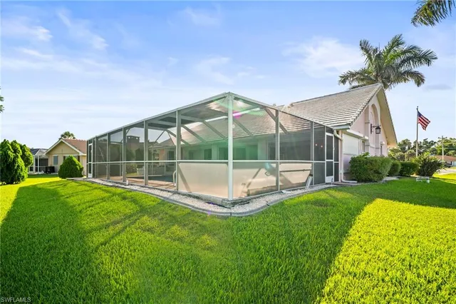 a view of a house with backyard and sitting area