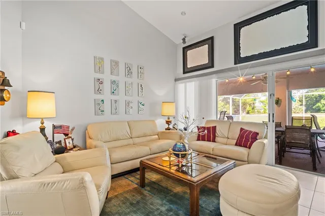 a living room with furniture and a wall painting