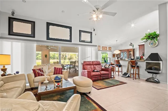 a living room with furniture or chandelier and a large window