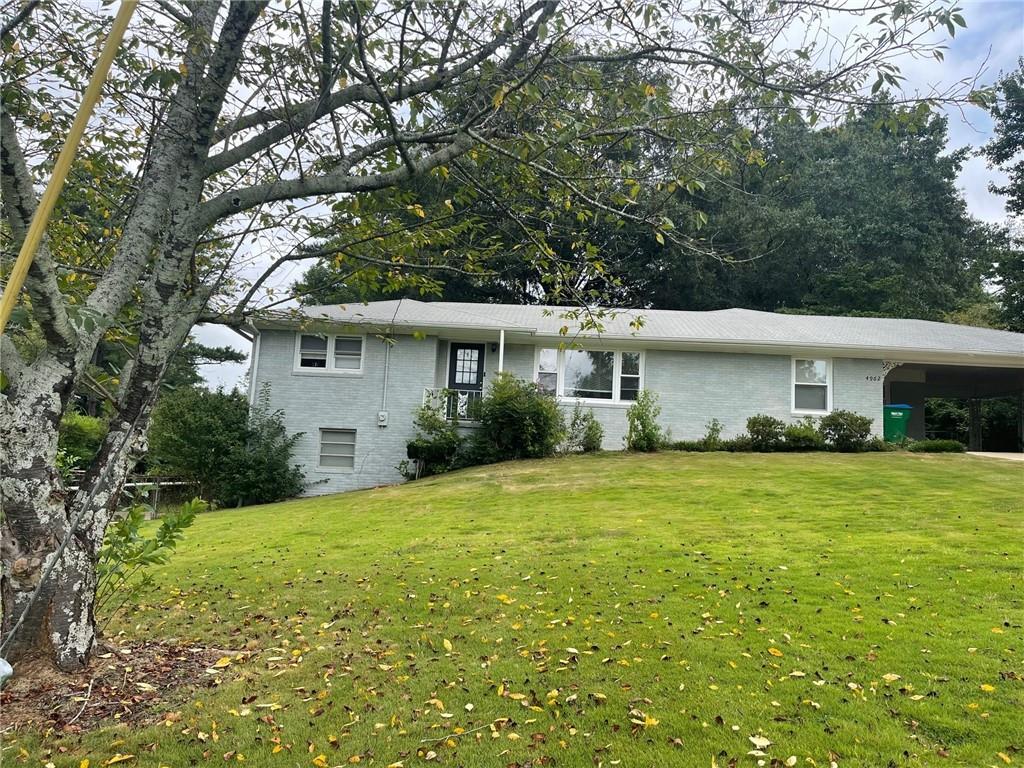 a front view of house with yard and green space