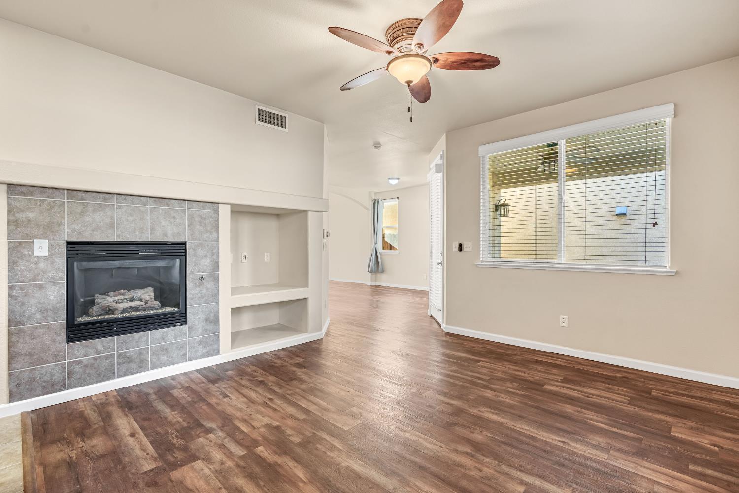 5629 North Citrus Lane Fresno, CA 93711 - Photo 12 of 35 a view of an empty room with a fireplace and a window