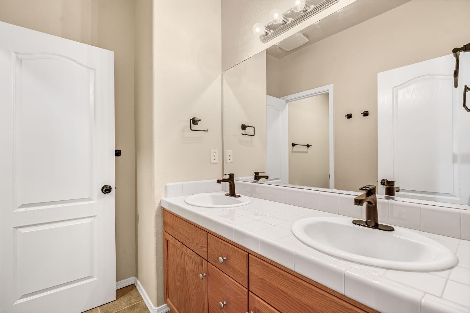 5629 North Citrus Lane Fresno, CA 93711 - Photo 18 of 35 a bathroom with a sink and a mirror