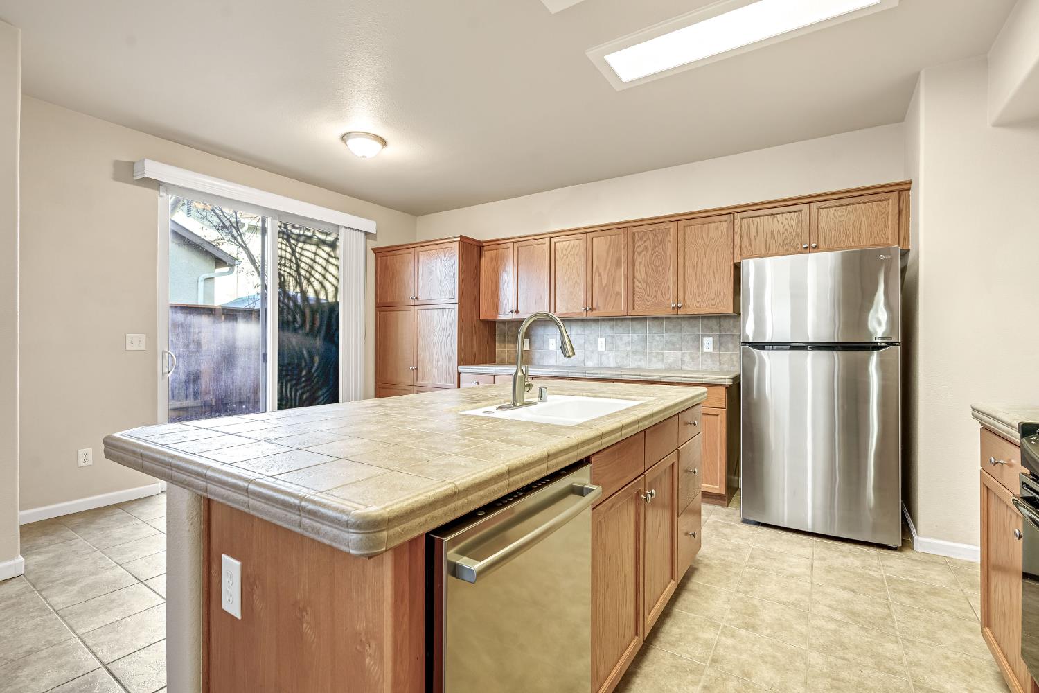 5629 North Citrus Lane Fresno, CA 93711 - Photo 2 of 35 a kitchen with granite countertop a refrigerator and a sink